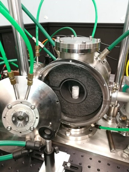 image of an experimental setup with a prism within a furnace within a cooled chamber for QCL material characterization