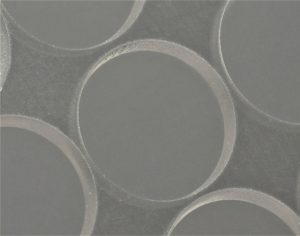 transparent sapphire material with clean cut circular features machined with a fluence ultrafast fiber laser